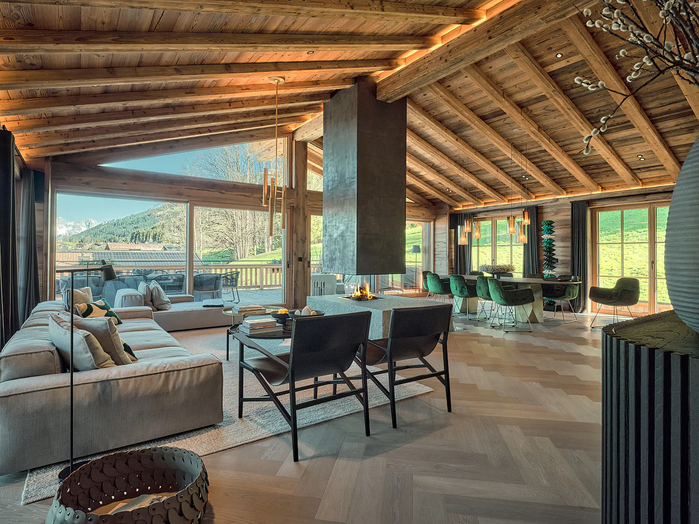 A spacious living room with wood floors, a stone fireplace, and a large window with a mountain view.