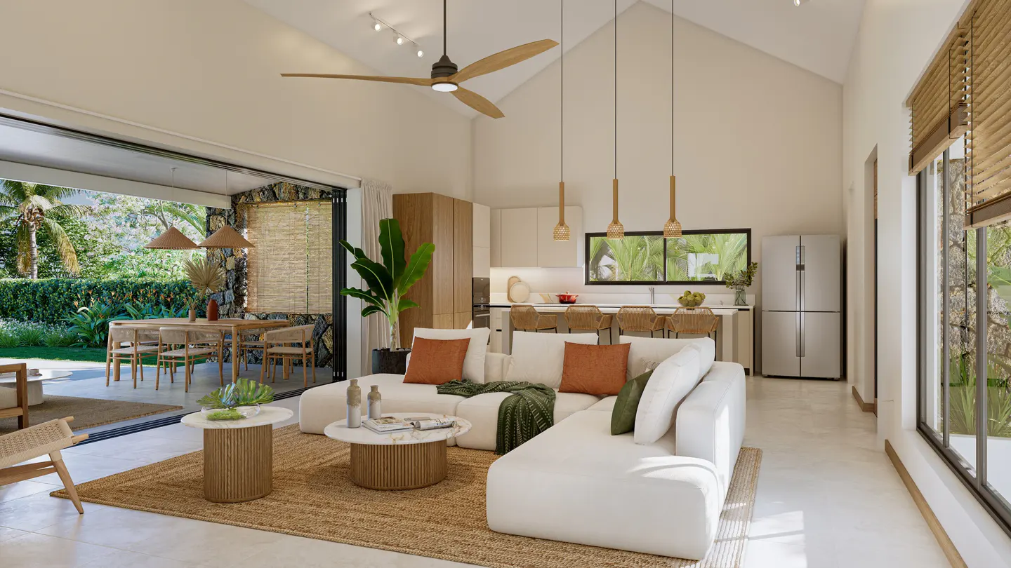 Bright, open-plan living room with white sofa, jute rug, and outdoor dining area visible through sliding glass doors. Modern kitchen in background.