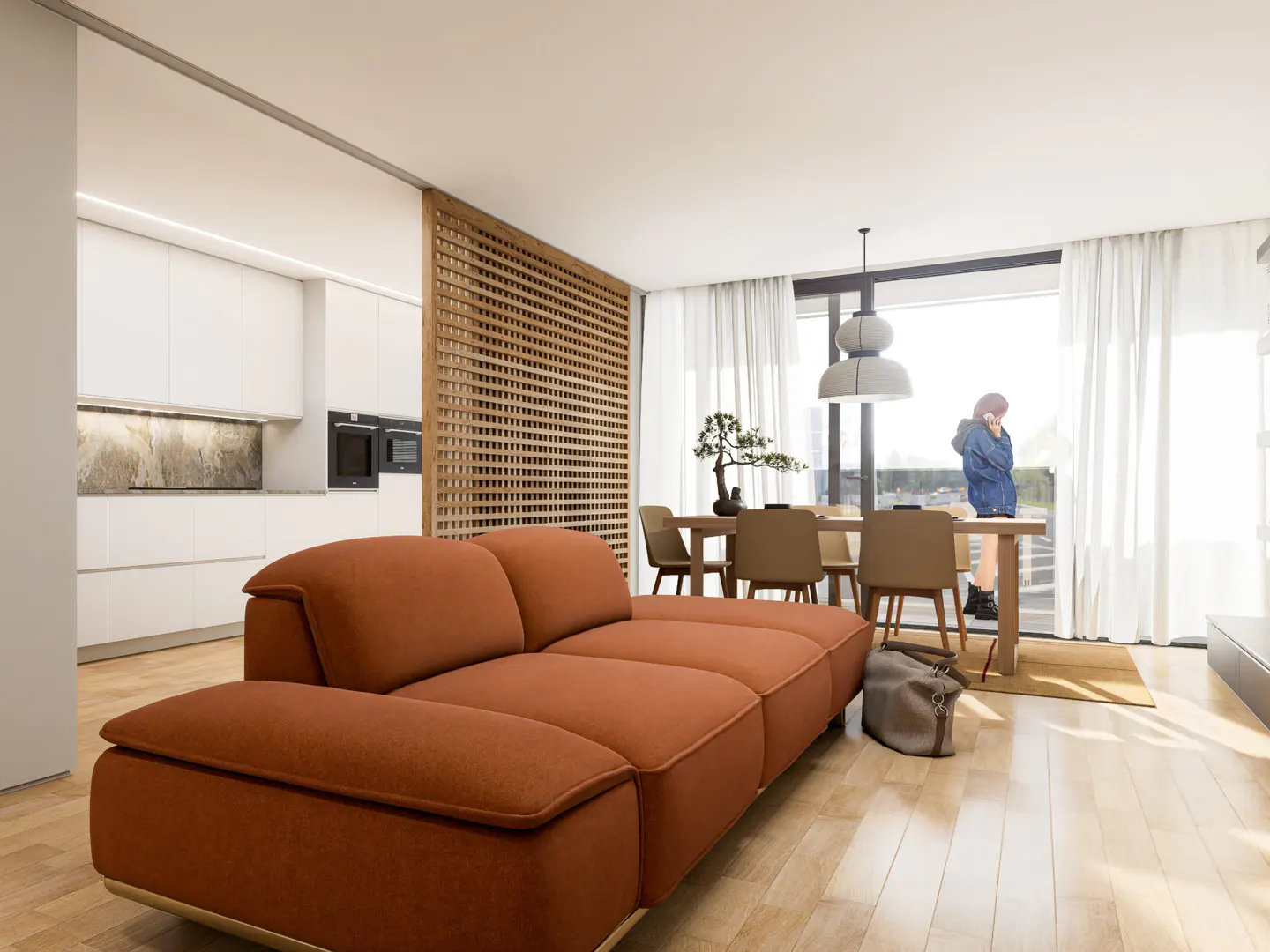 Bright, modern living space with an orange sofa, dining table, and a woman by the window. White kitchen cabinets are visible in the background.