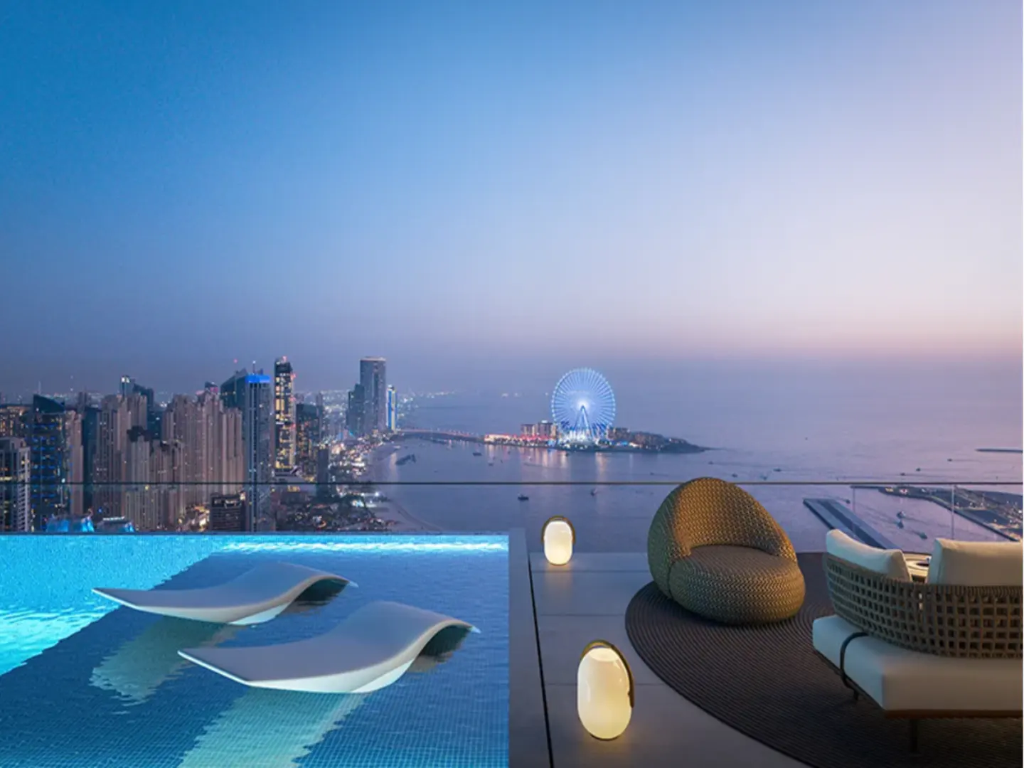 Rooftop pool with lounge chairs, overlooking Dubai skyline at dusk. A Ferris wheel is visible in the distance. Wicker chairs and lamps on the patio.