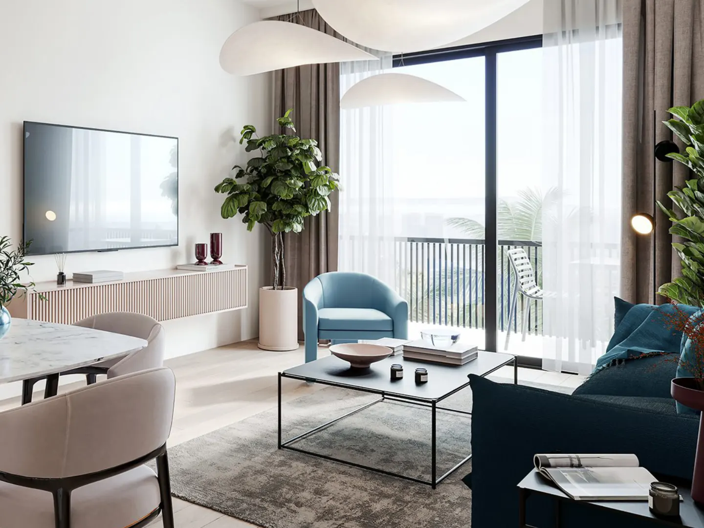 Bright living room with a blue armchair, dark blue sofa, and a black coffee table facing a balcony with ocean views.