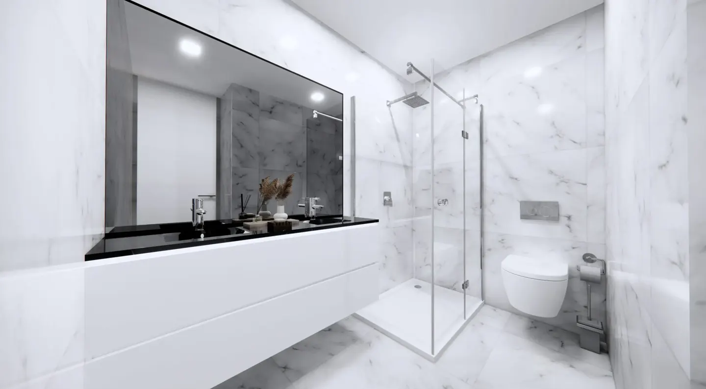 A modern bathroom with marble walls, a glass shower, and a white vanity with a black countertop.