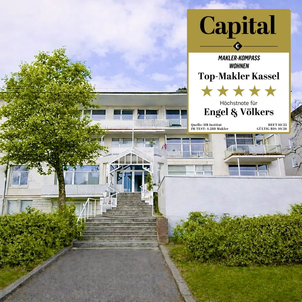 Exterior of a white, multi-story building with stairs leading to the entrance. A "Capital" award logo is displayed.