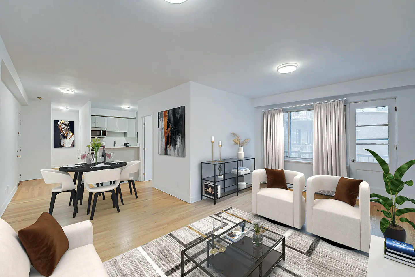 Bright living room with white walls, hardwood floors, and a black dining table. Two white armchairs face a window with beige curtains.