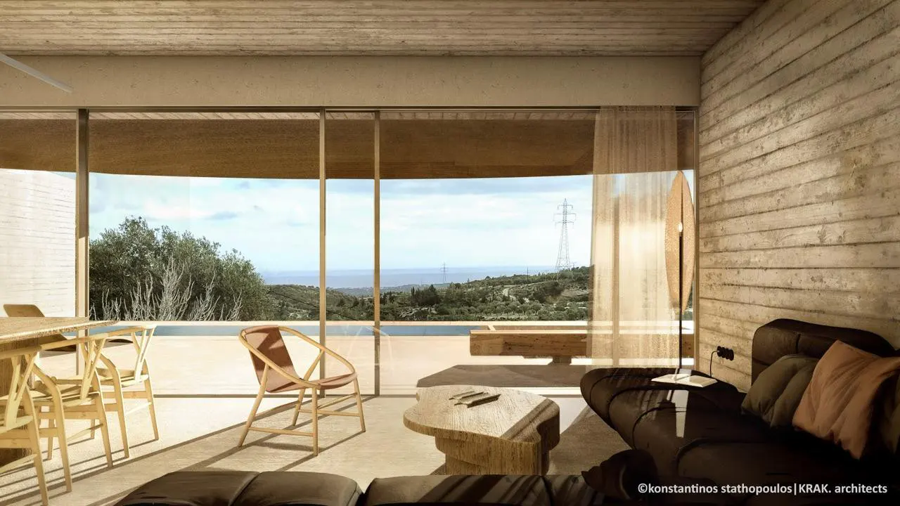Living room with concrete walls, a brown sofa, and a large window overlooking a pool and landscape.