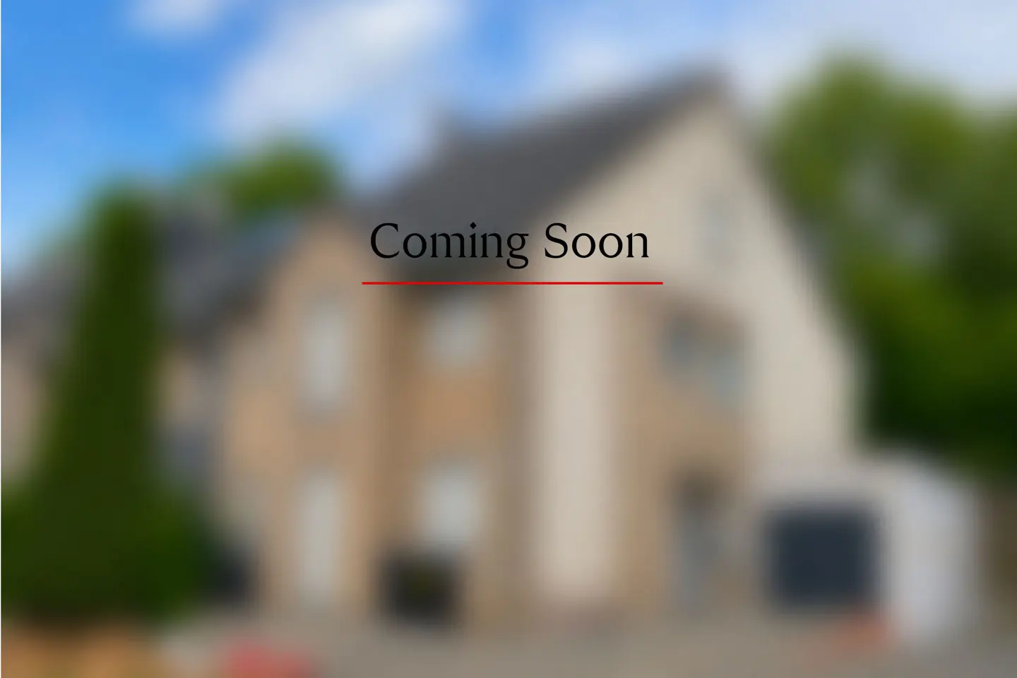 Blurred image of a two-story house with "Coming Soon" text overlayed in black with a red underline.