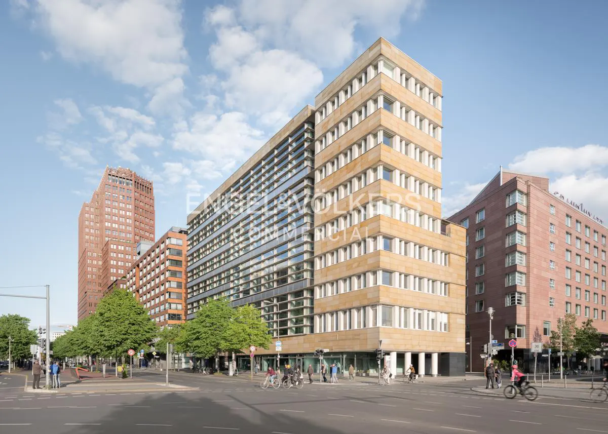 Street view of modern buildings in Berlin, Germany. Pedestrians and cyclists are on the street.