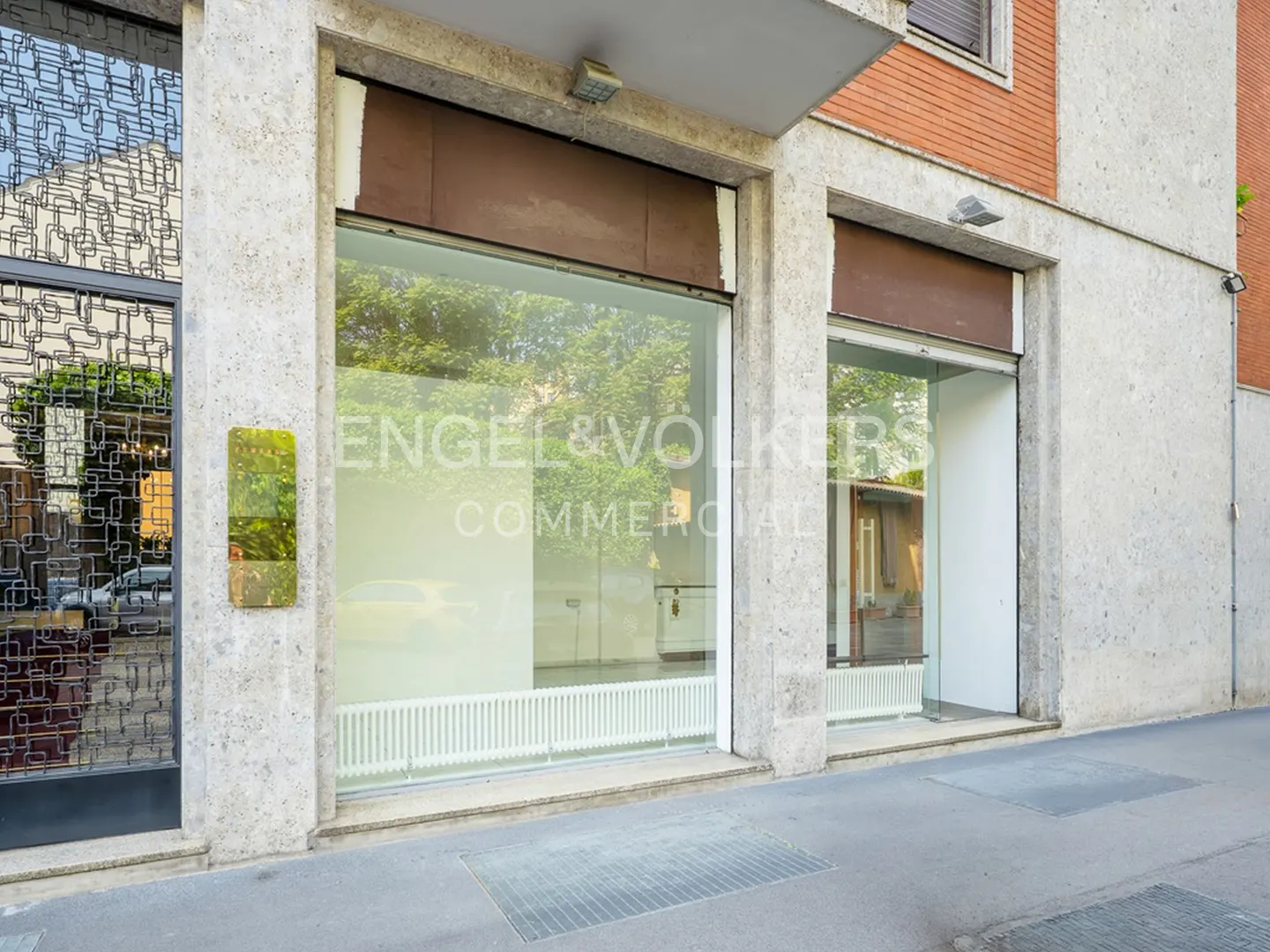 Exterior view of Engel & Volkers Commercial office with large windows and a decorative metal screen.