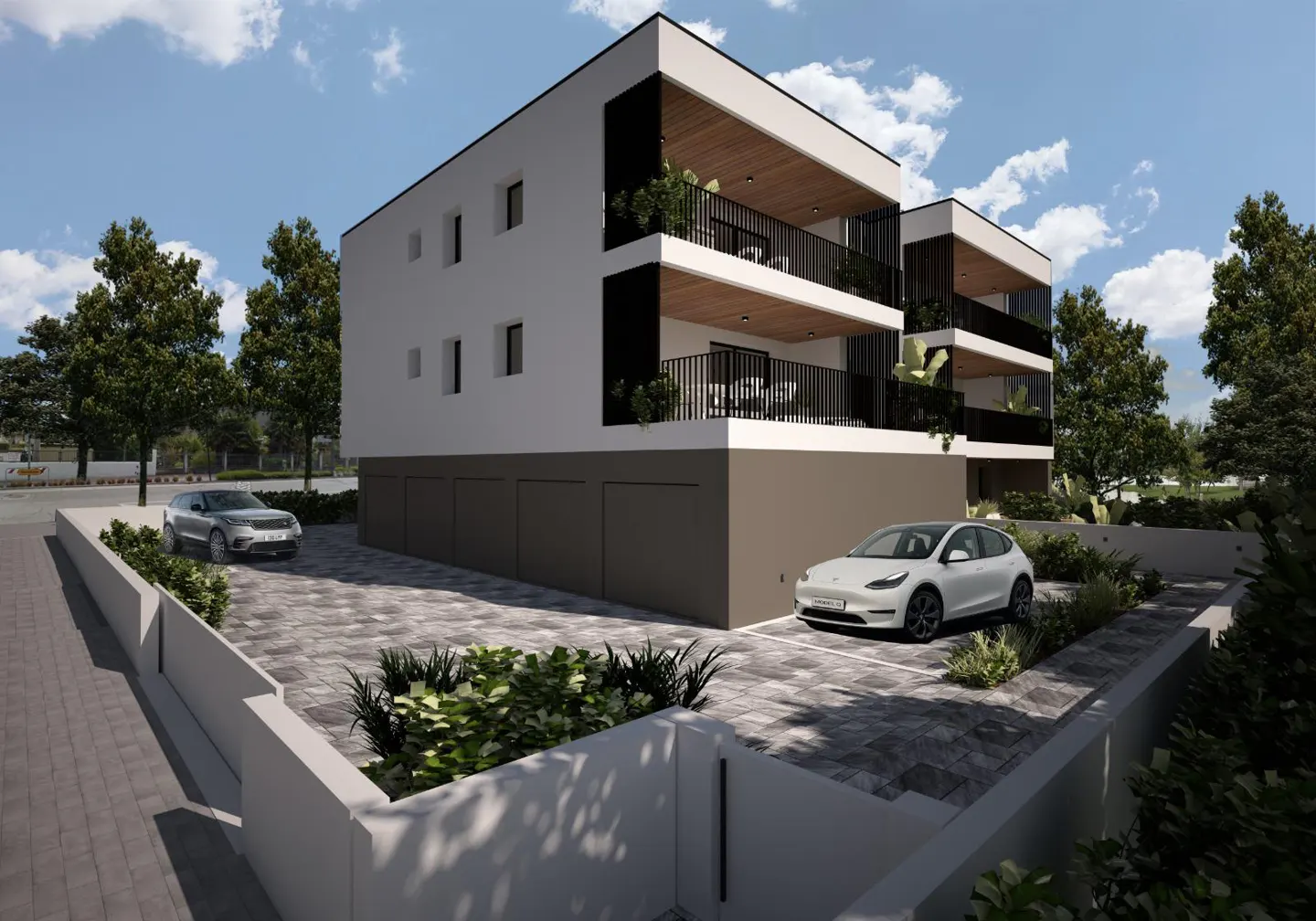 Modern three-story apartment building with black balconies, white walls, and a gray base. Two cars are parked in the paved lot.