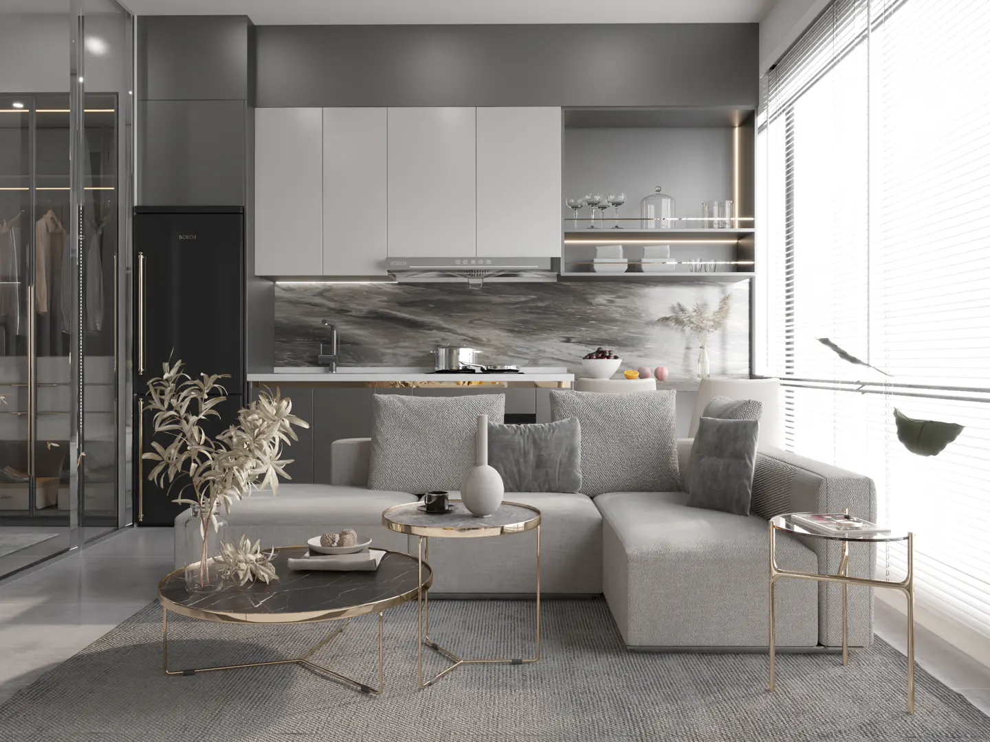 Modern living room with a gray sectional sofa, marble coffee tables, and a kitchen in the background. Large windows with blinds provide natural light.