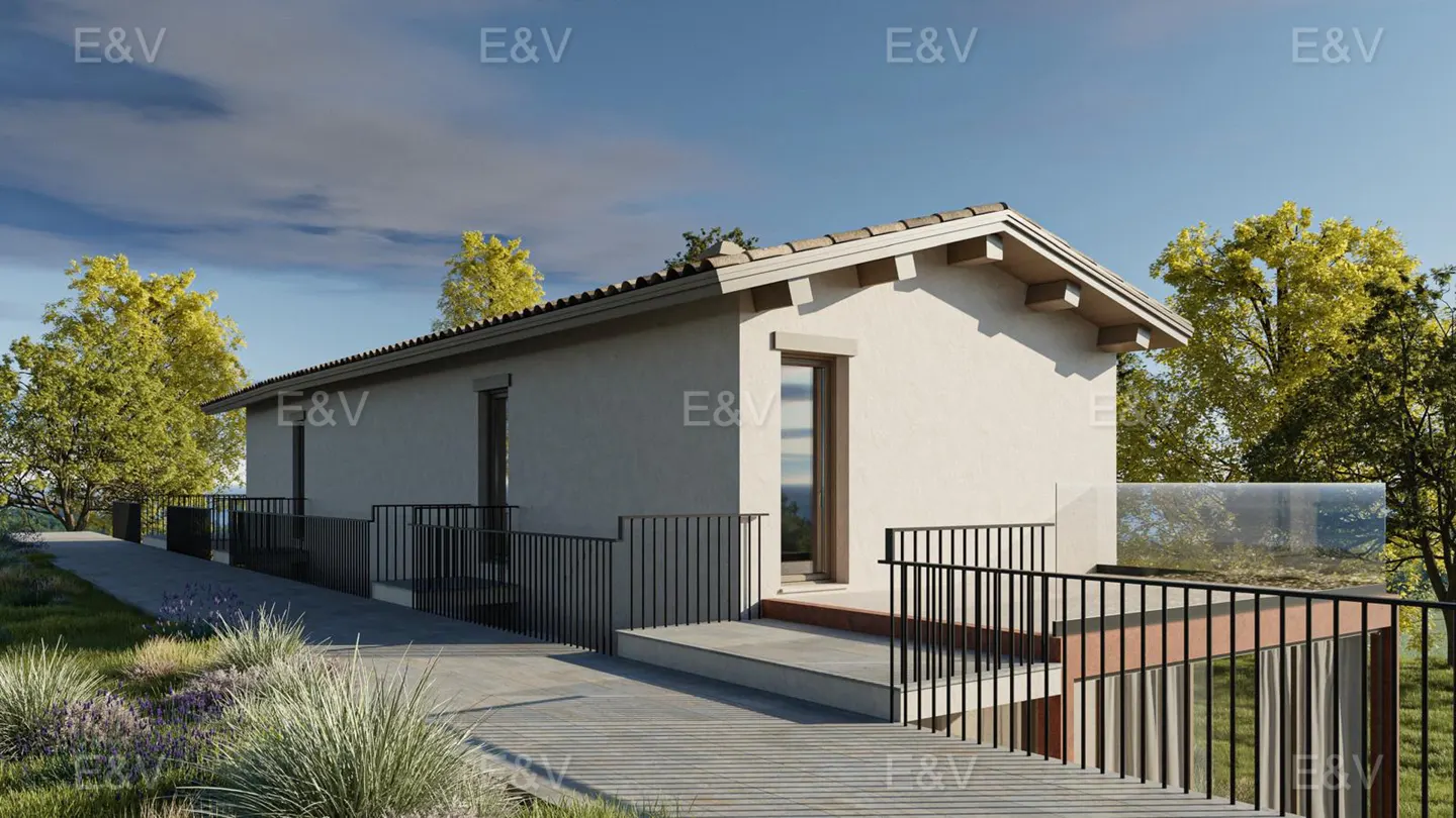 Beige single-story house with a brown tile roof, black railings, and a concrete walkway surrounded by green grass and trees.