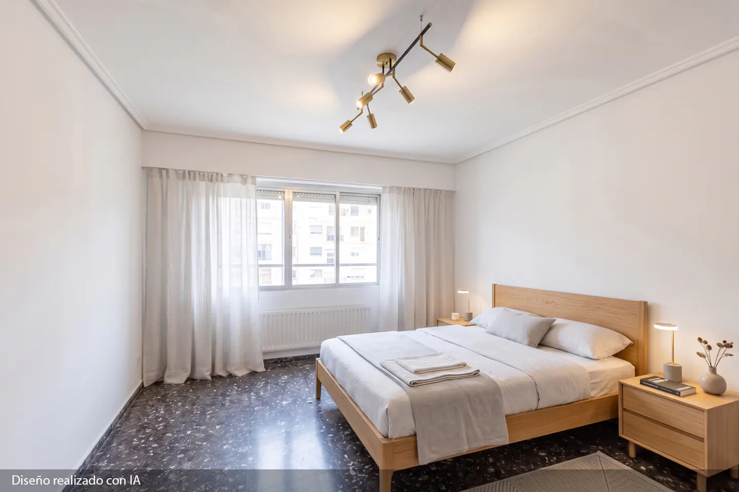 Bright bedroom with a wooden bed frame, white bedding, and matching nightstands. A modern gold light fixture hangs from the white ceiling. Window with white curtains.