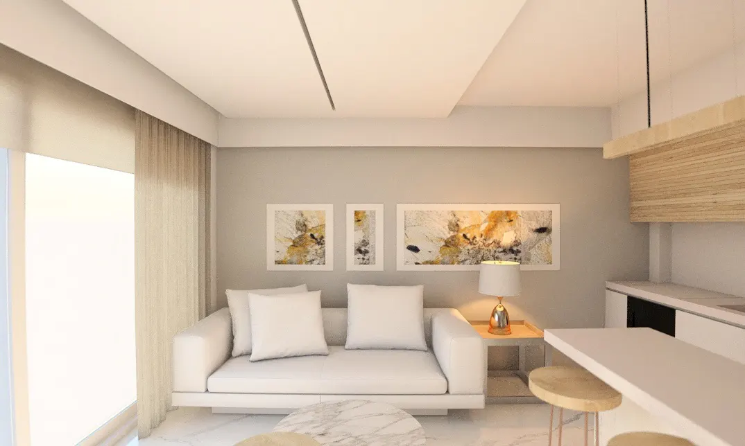 Modern living room with a white sofa, marble coffee table, abstract wall art, and a kitchen island with wooden stools.