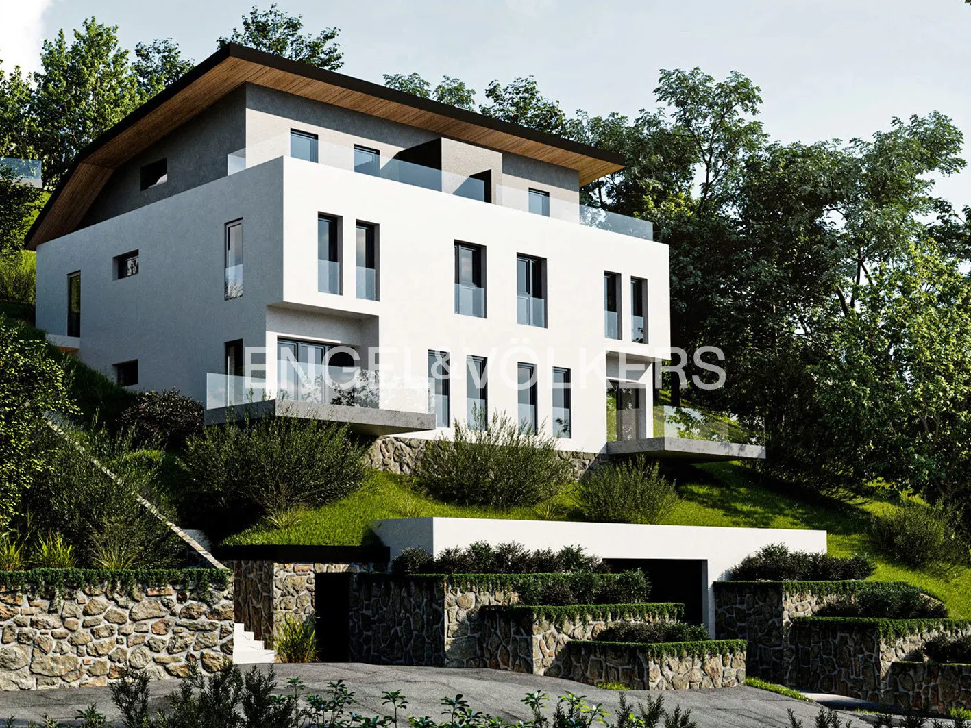 Modern white three-story house with black framed windows, surrounded by green trees and stone walls.