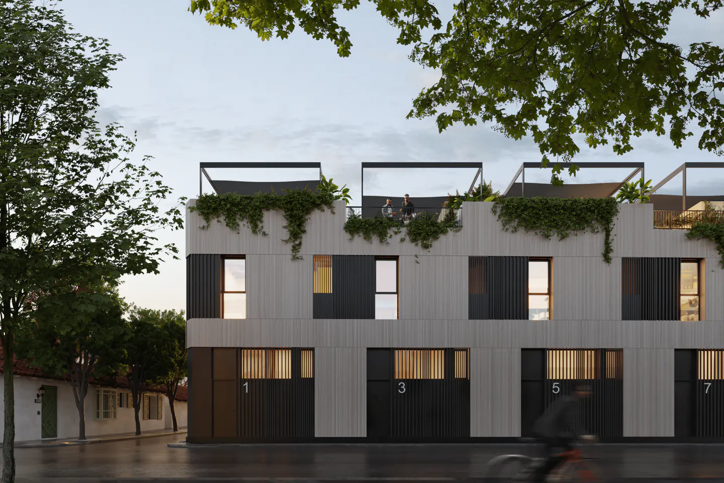 Modern townhouses with light wood and black panels, rooftop terraces, and greenery, viewed from a street with a cyclist.