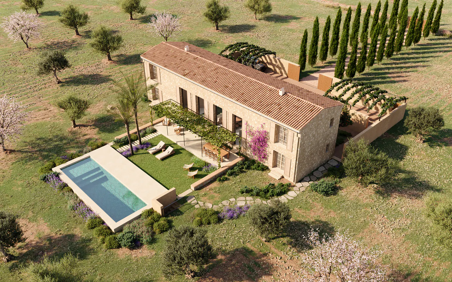 Aerial view of a stone house with a terracotta roof, pool, pergola, and landscaping in a grassy field.