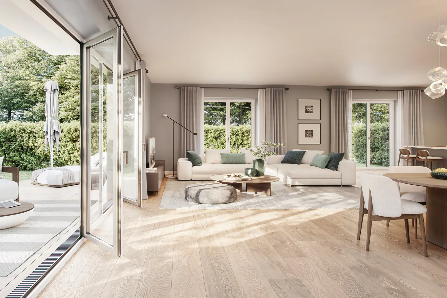 Bright, modern living room with white sofa, wood floors, and open doors to a patio with green foliage.