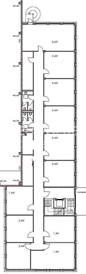 Floor plan of a building with multiple apartments, a central hallway, and a staircase. Bathrooms are located on the left side of the hallway.