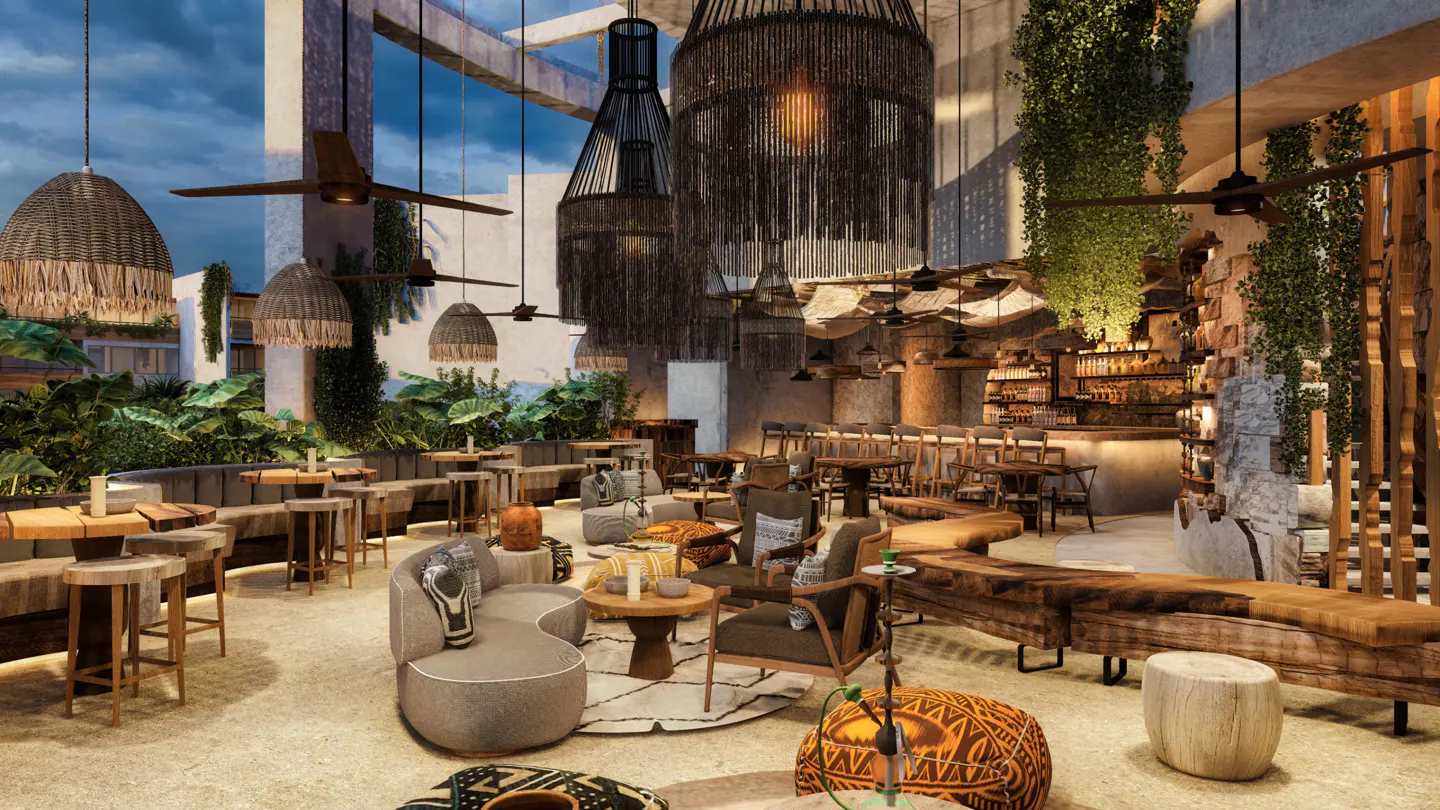 Interior of a stylish bar with wooden furniture, hanging lights, and lush greenery. A bar area is visible in the background.