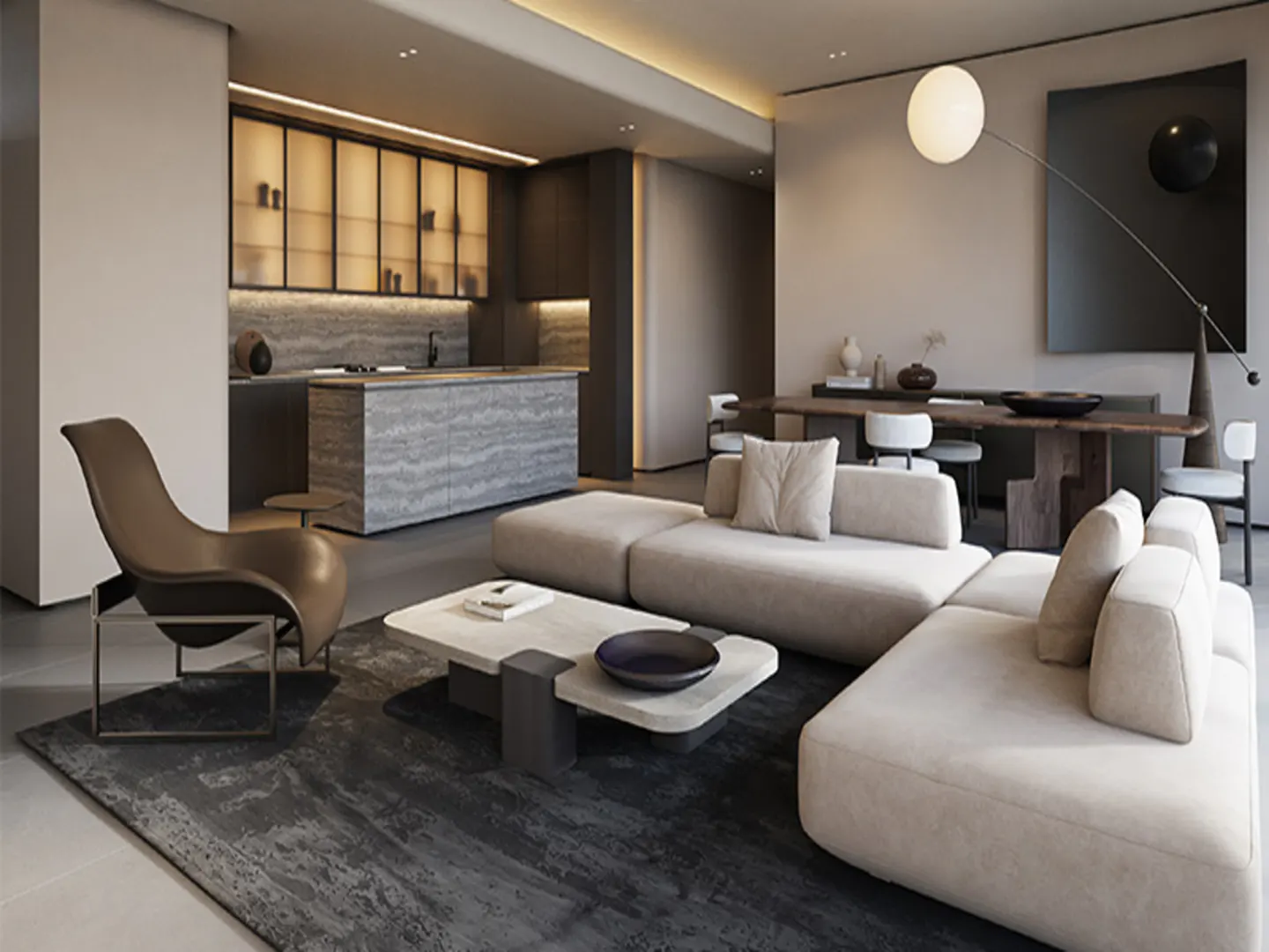 A modern living room with a beige sectional sofa, marble coffee table, and a brown leather chair on a dark rug. In the background, there is a kitchen with marble countertops and a dining table with chairs. A large black painting hangs on the wall.