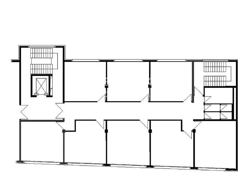 Black and white floor plan showing two rows of rooms, stairs, and an elevator.