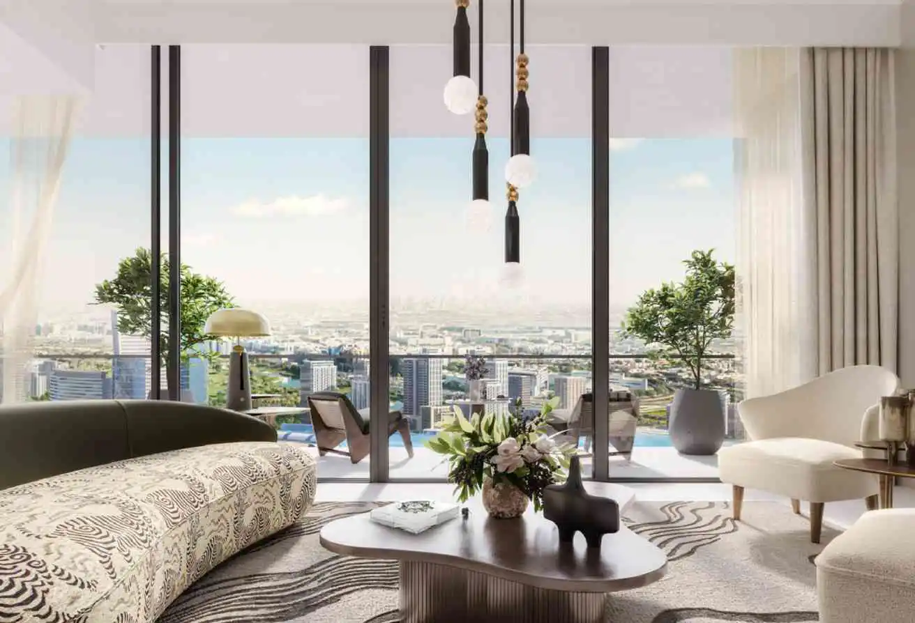 Modern living room with patterned sofa, coffee table, and floor-to-ceiling windows overlooking a sunny city skyline.