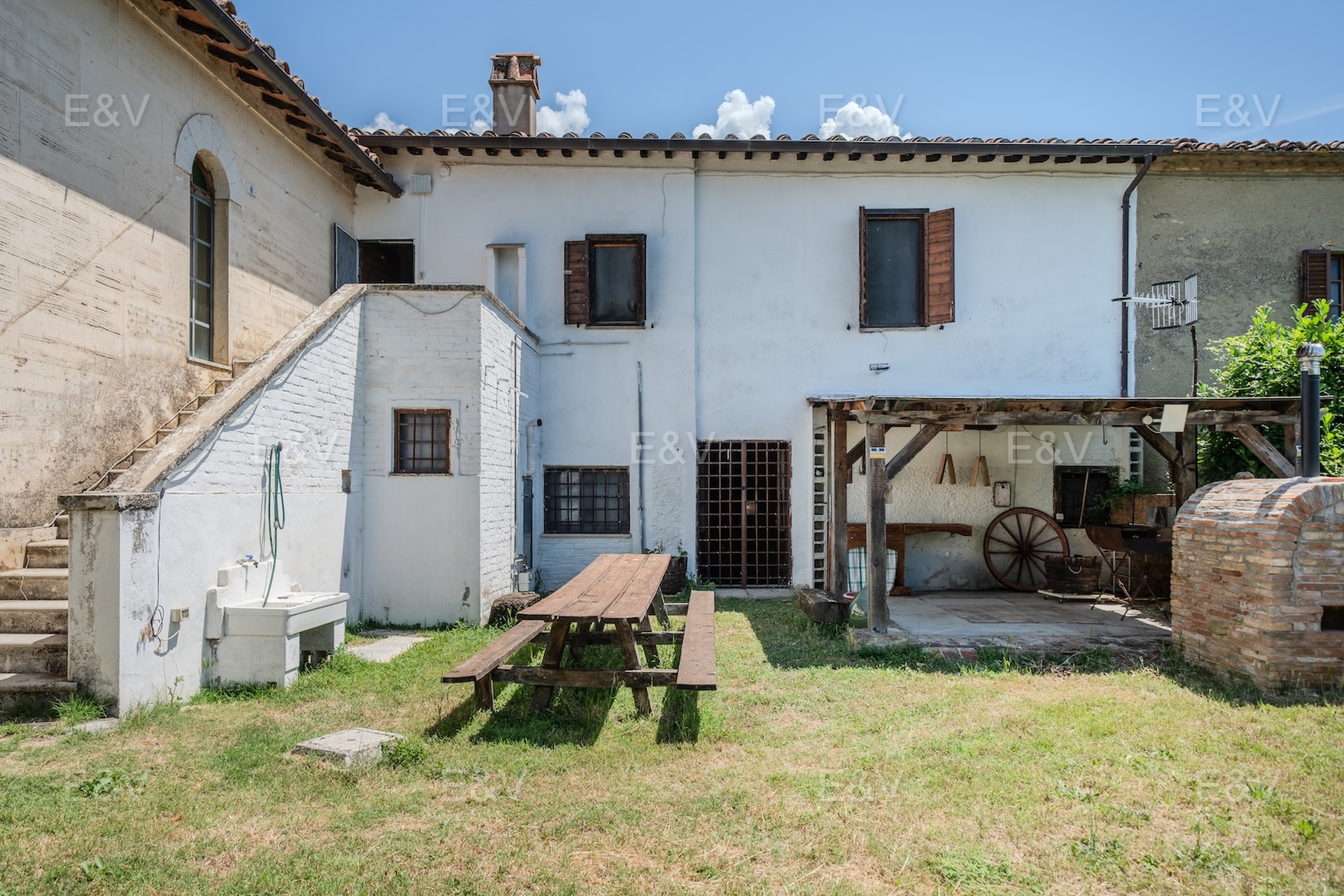 Portion of farmhouse nestled in the green hills of the Upper Tiber Valley