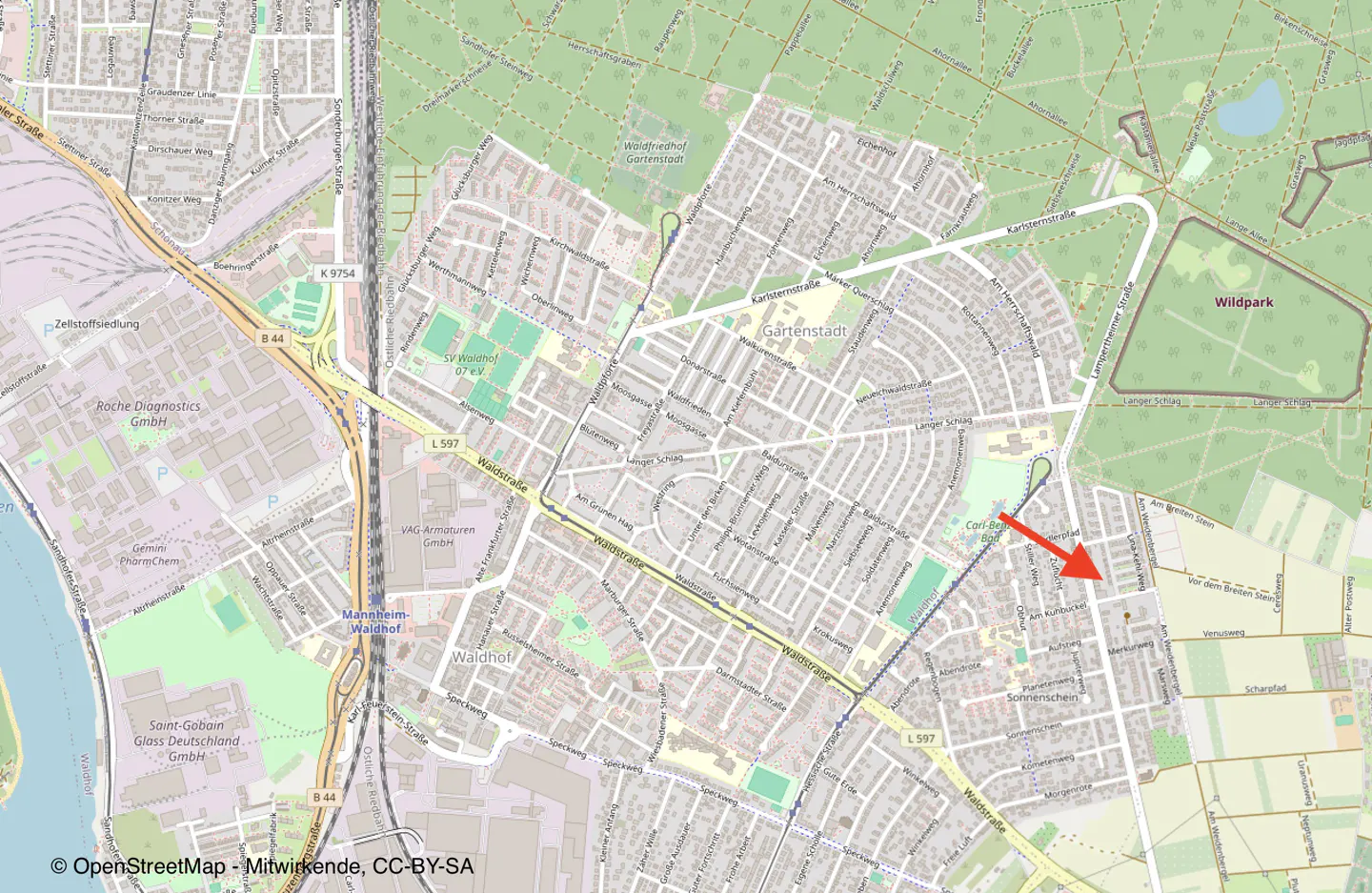 Map view of Gartenstadt neighborhood with streets, buildings, and green spaces. Red arrow points to a specific location.
