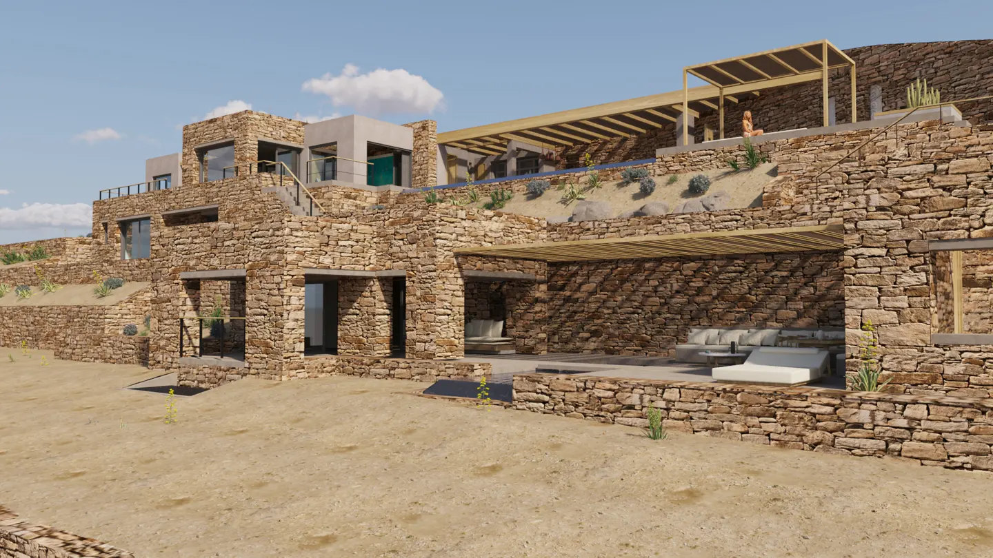 Exterior view of a multi-level stone house with a pergola, pool, and patio furniture on a sunny day.