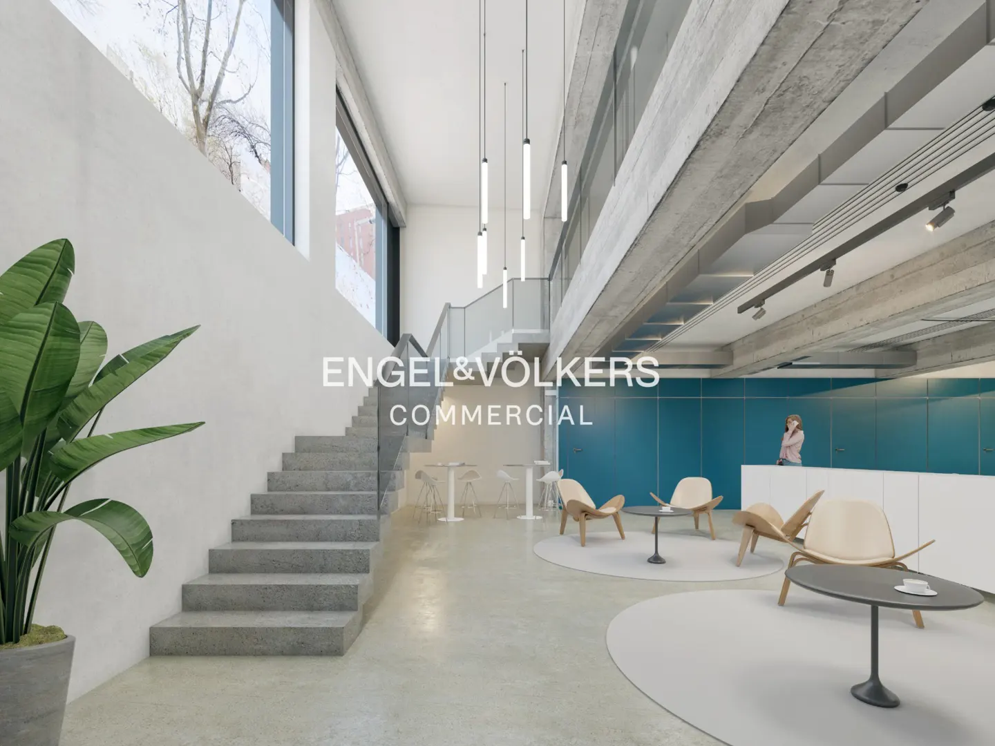 Engel & Völkers commercial space with stairs, modern lighting, and a reception area with chairs and tables.
