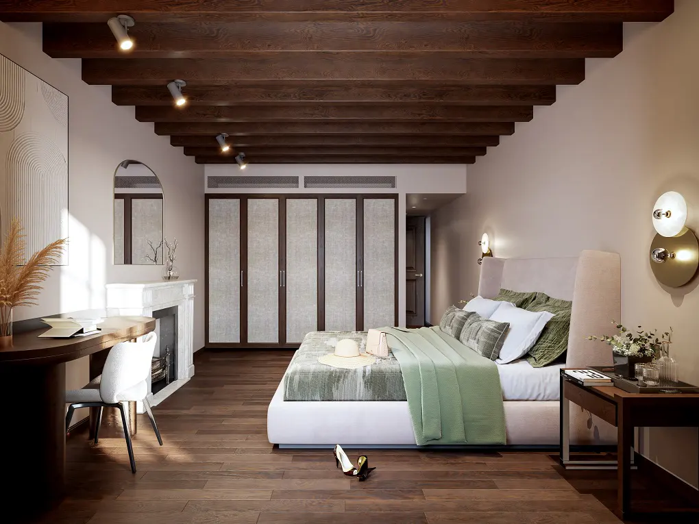 Bedroom with dark wood floors, exposed beams, a desk, and a bed with green accents.