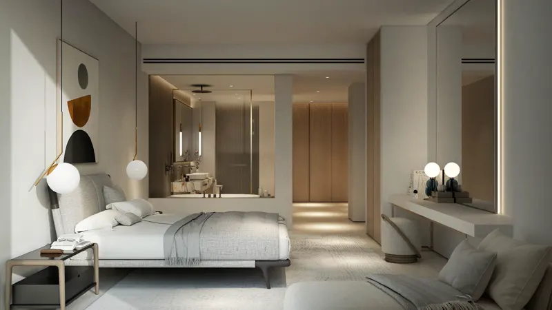 Modern bedroom with a neutral color palette, featuring a bed, glass-walled bathroom, vanity area, and soft ambient lighting.
