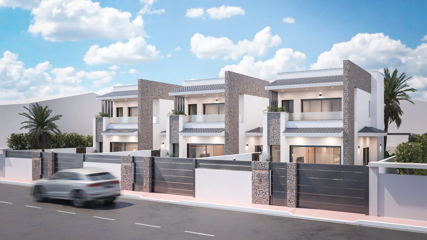 Three modern, two-story white townhouses with stone accents and gray fences under a blue, cloudy sky. A silver car drives on the street.