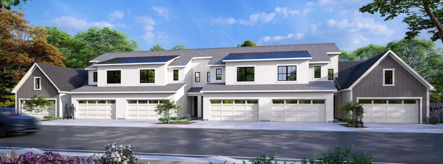 Modern three-unit townhouse with white siding, gray roof, and white garage doors. Solar panels are visible on the roof.