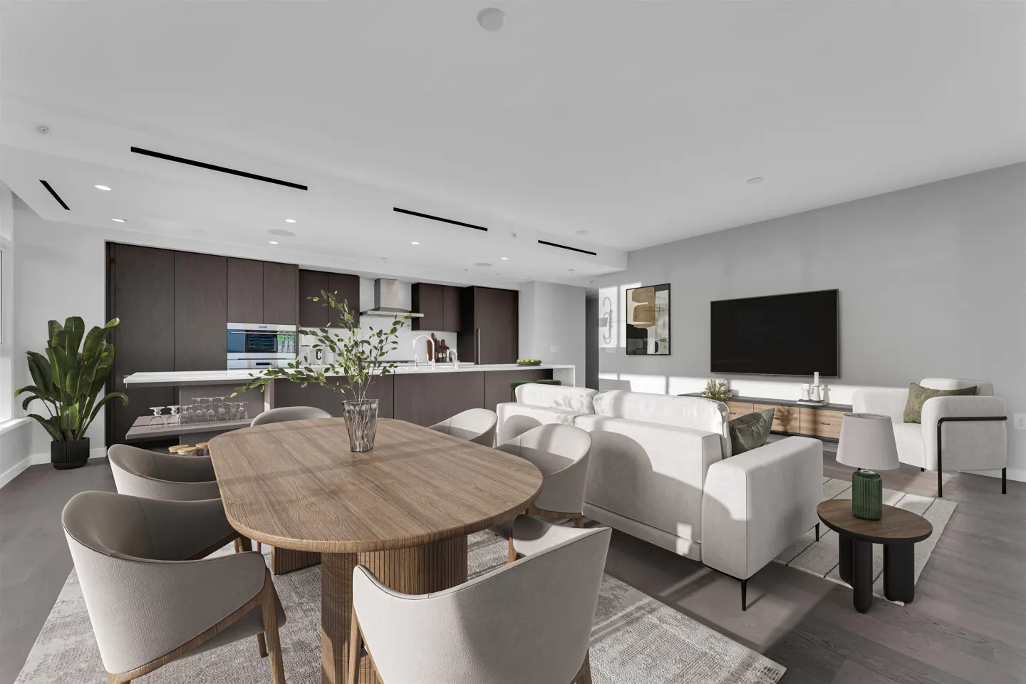 Open-concept living space with a wood dining table, white sofa, and dark brown kitchen cabinets.