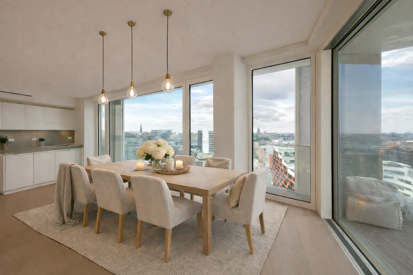 Bright dining area with a light wood table, six chairs, and pendant lights. Large windows offer a city view.