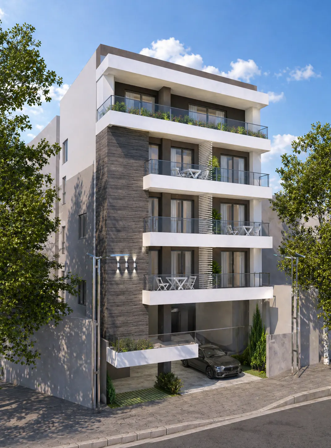 Modern apartment building with balconies, gray stone accents, and a black car parked underneath. Blue sky and trees in the background.