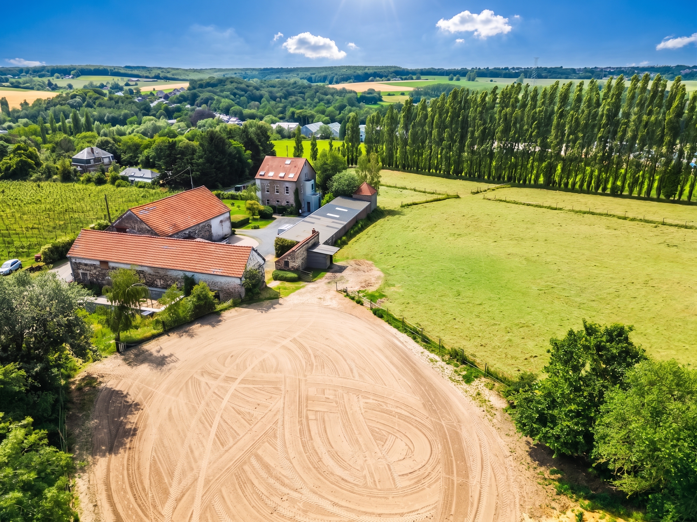 Equestrian property with riding arena and stables surrounded by open fields