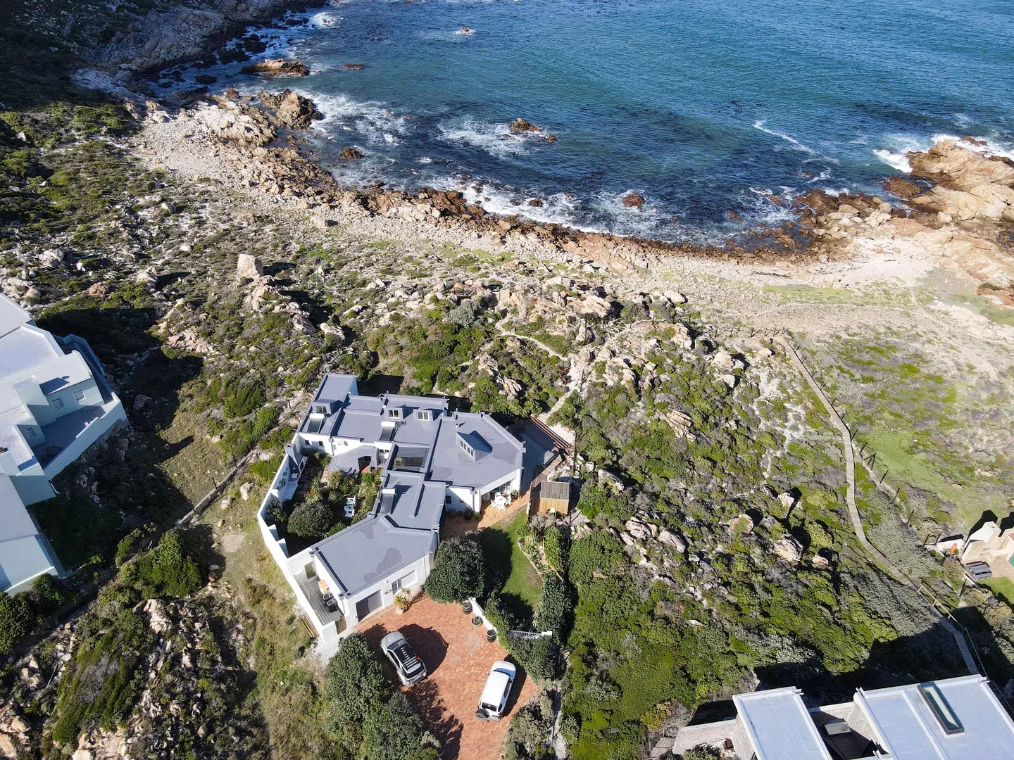 Private courtyard fitted with a pizza oven, built-in braai, outdoor hot & cold shower and stairs leading upto the rooftop deck