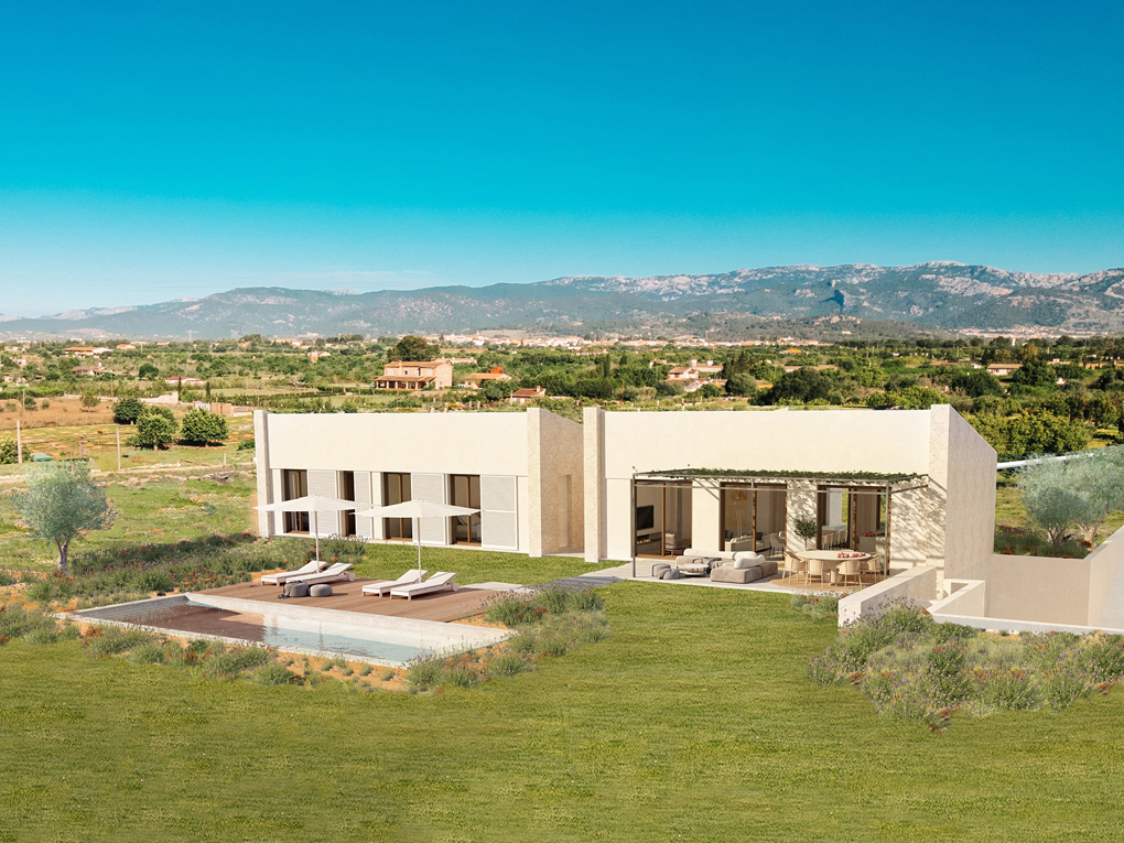 Modern beige villa with a pool, wooden deck, and outdoor dining area, set in a rural landscape with distant mountains.