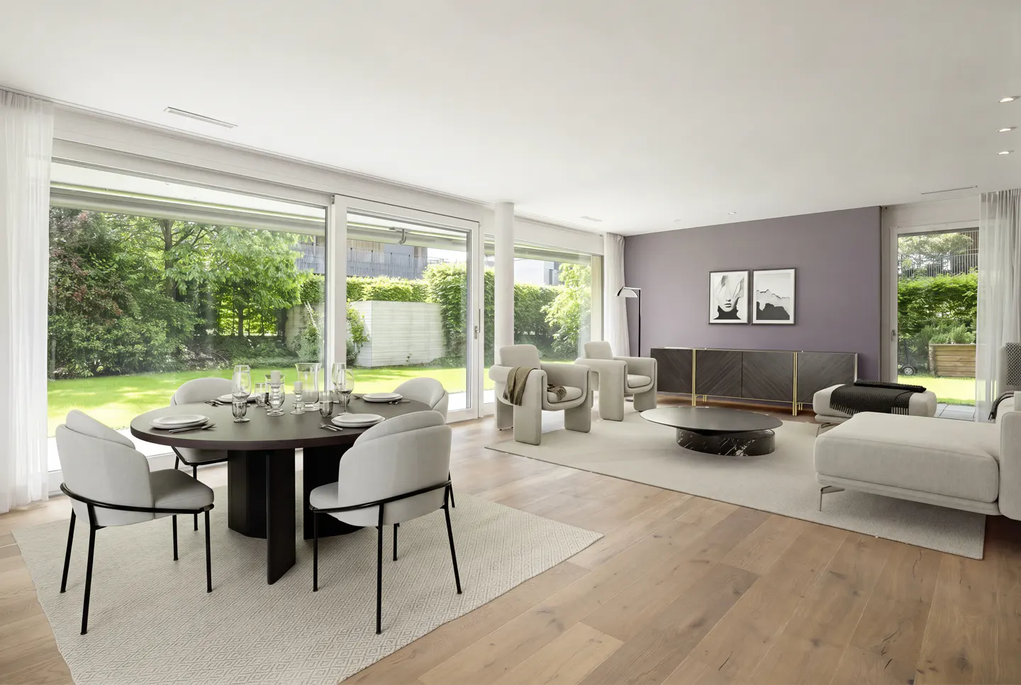 Bright, modern living room with wood floors, a round dining table with six chairs, and a large window overlooking a green lawn.