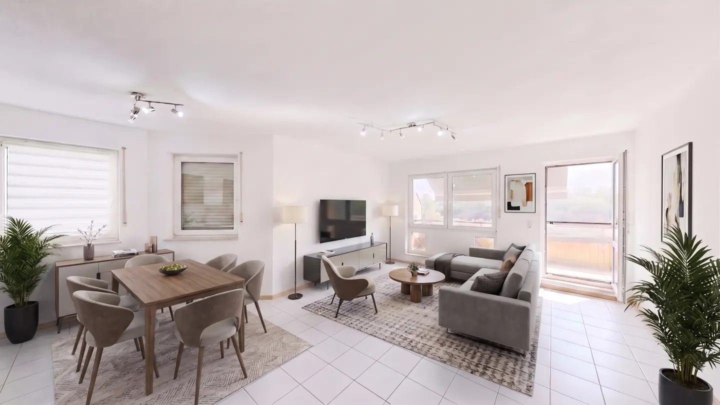 Bright, open-plan living and dining area with white walls, tiled floor, grey sofa, wooden table and chairs, and balcony access.