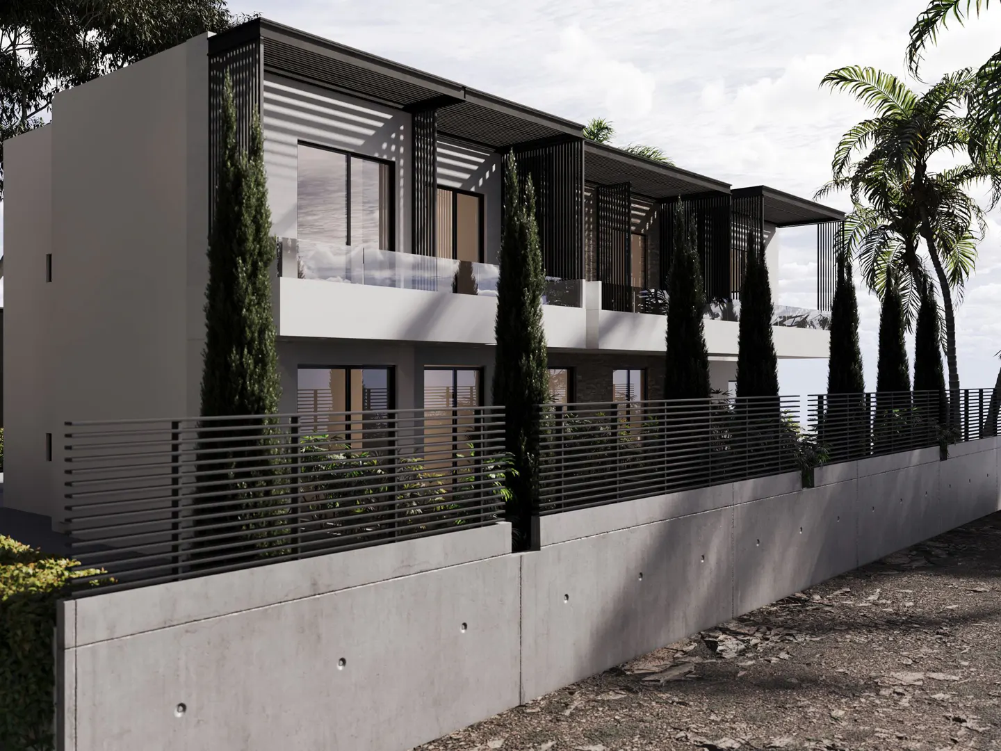 Modern two-story townhouses with balconies, black metal accents, and a concrete retaining wall. Palm trees in the background.