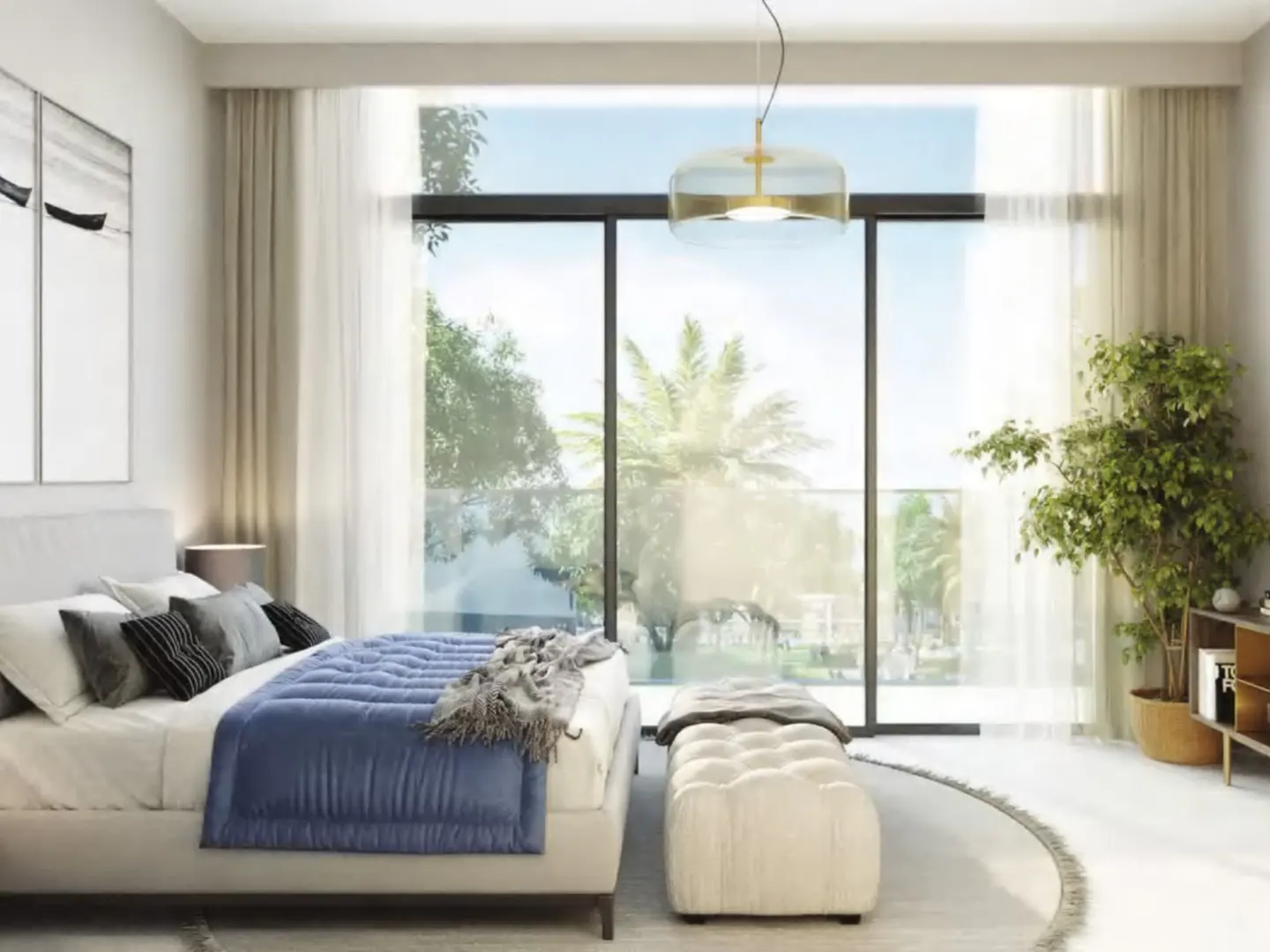 Bright bedroom with a blue-covered bed, white ottoman, and a large window showing a sunny outdoor view. A modern pendant light hangs above.