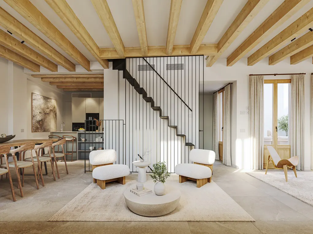 Bright, open-plan living space with wooden beams, dining table, kitchen, and lounge area with white chairs and a round coffee table.