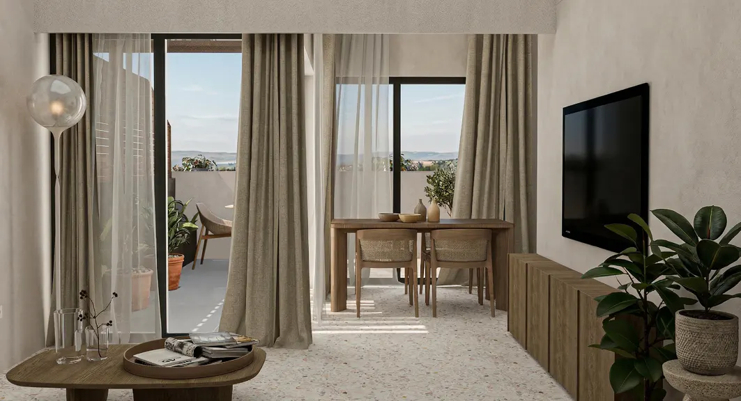 Living room with beige curtains, a wooden table and chairs, a TV, and plants. Balcony with a view in the background.