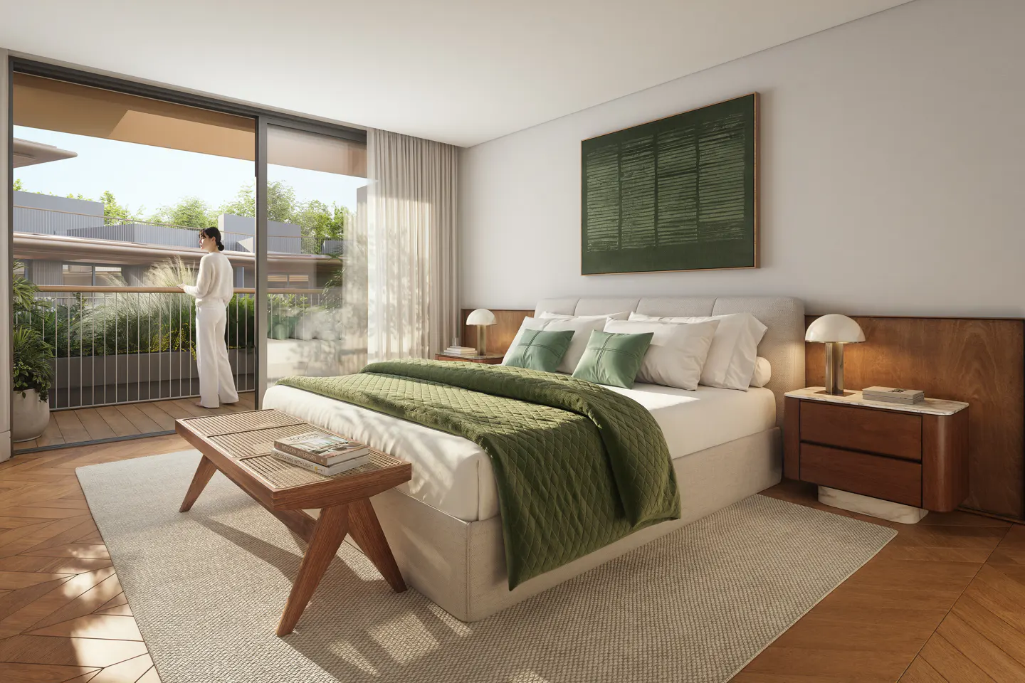 A bright bedroom with a woman on the balcony. The bed has a green quilt and pillows. A wooden bench sits at the foot of the bed.