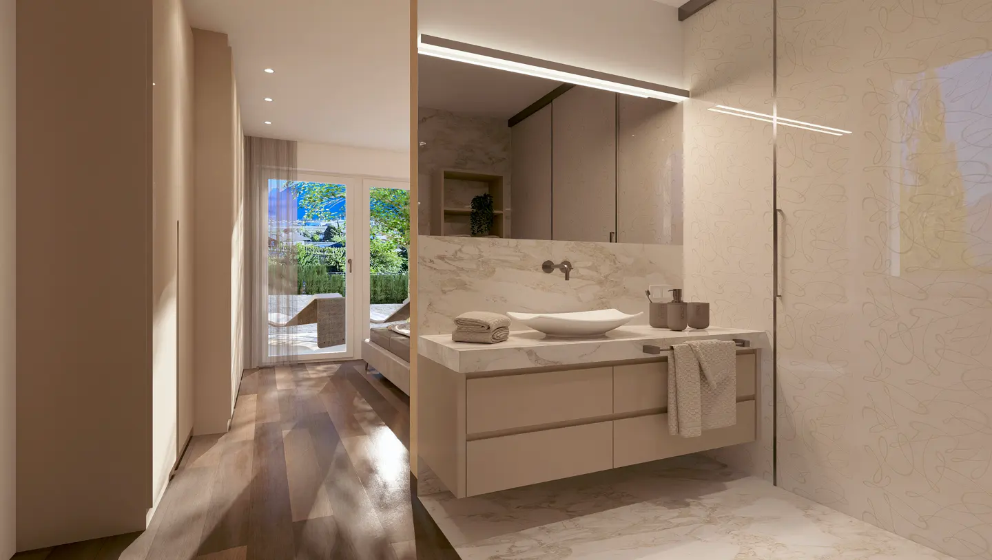 A modern bathroom with a marble countertop, white sink, and beige cabinets. A view of a garden is visible through a doorway.