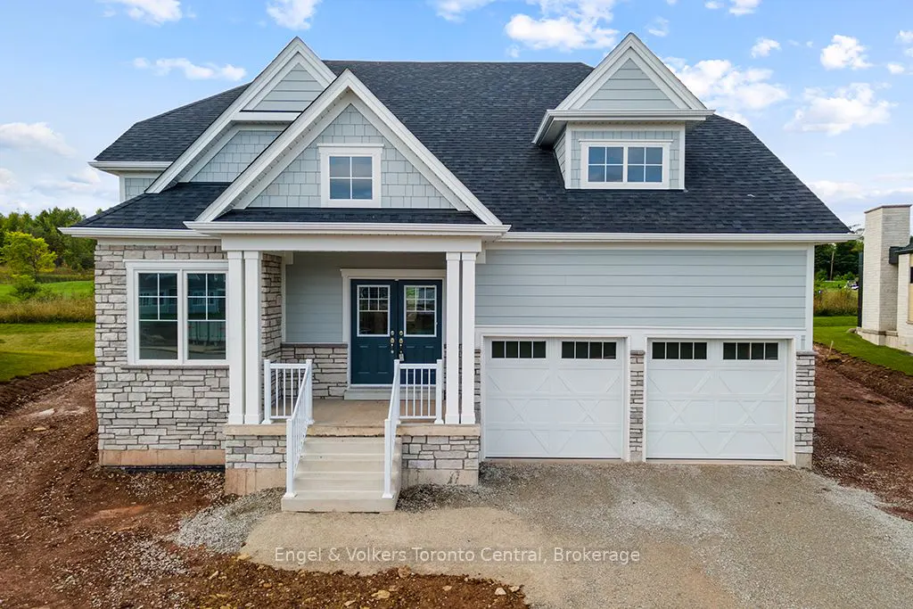 Two-story house with stone and light blue siding, a dark roof, and a two-car garage.