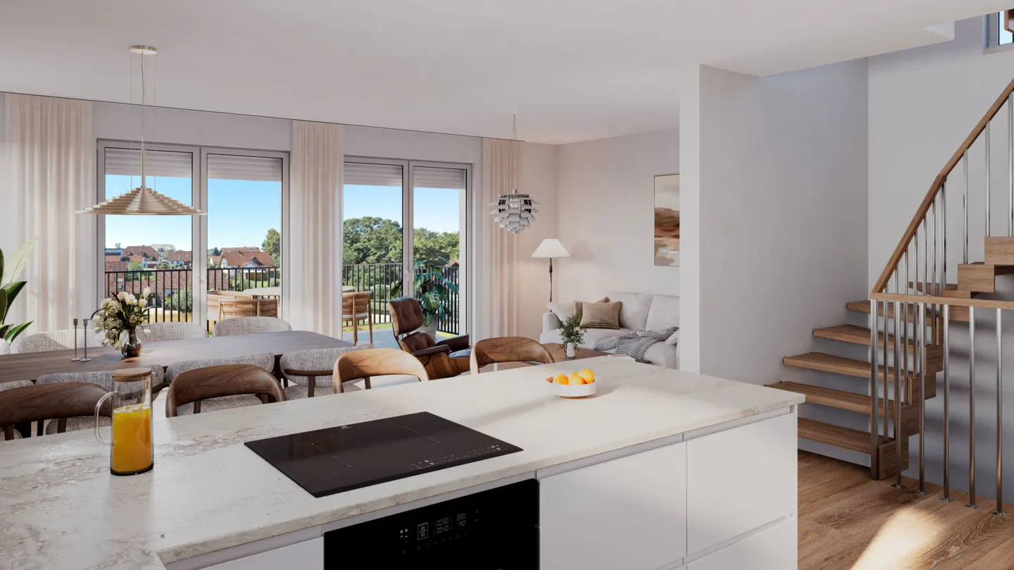 Modern open-plan kitchen with white island, dining area, and wooden staircase leading to an upper floor.